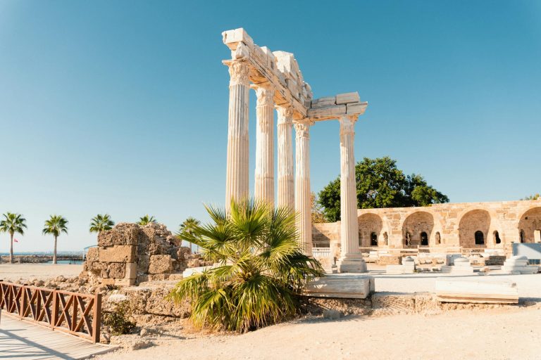 Discover the ancient ruins of the Temple of Apollo in Side, Antalya, against a clear blue sky.